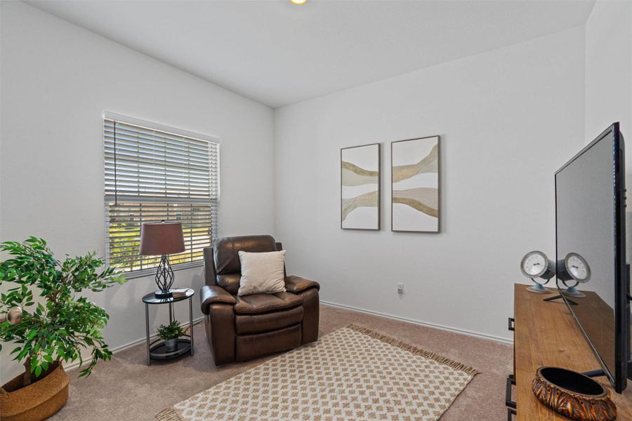 Sitting room featuring carpet
