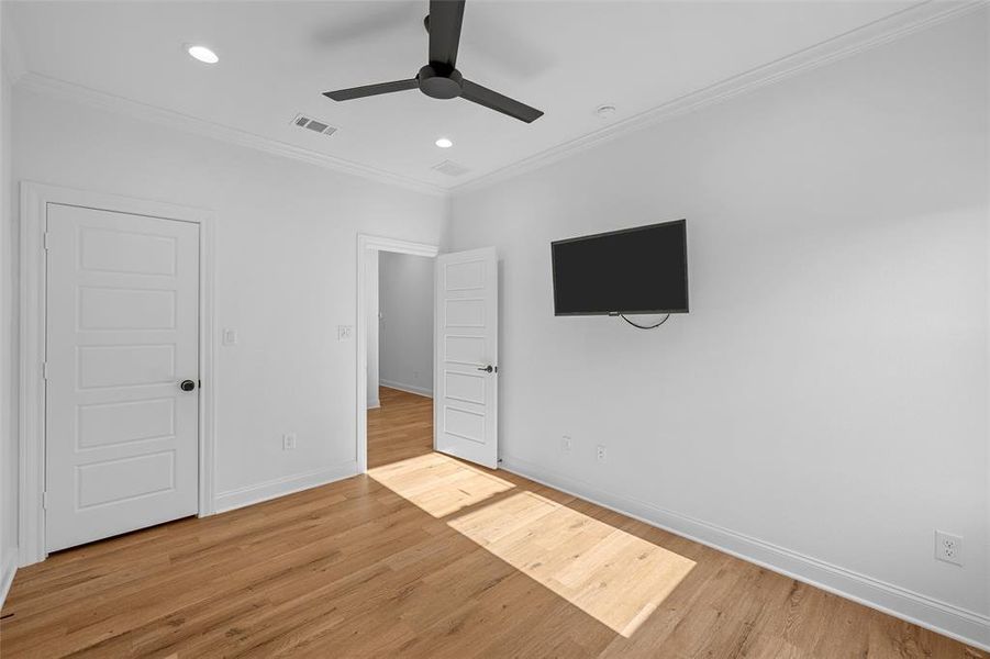 Unfurnished bedroom featuring ornamental molding, light wood-type flooring, recessed lighting, and ceiling fan Unfurnished bedroom featuring ornamental molding, light wood-type flooring, recessed lighting, and ceiling fan