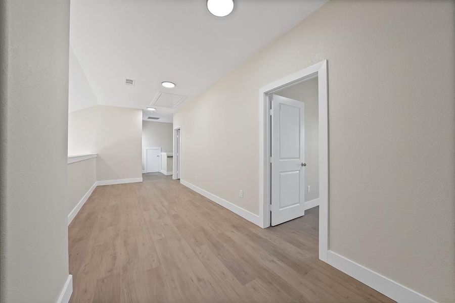 Hallway with baseboards and light wood-style flooring