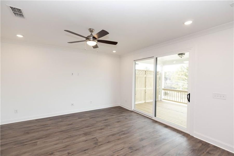 Family room - Ceiling fan and sliding glass door in fabulous. Pictures represent a previously built home, not the actual home.
