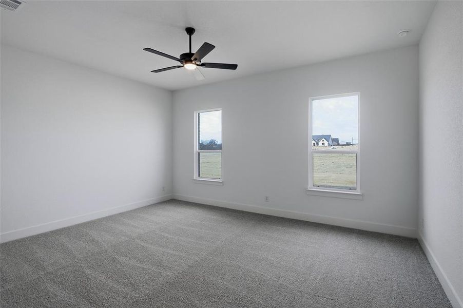 Unfurnished room with carpet floors and a ceiling fan