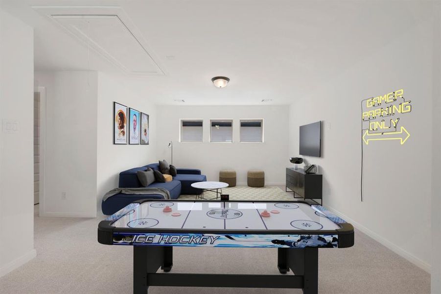 Carpeted bonus room with recessed lighting and three horizontal windows