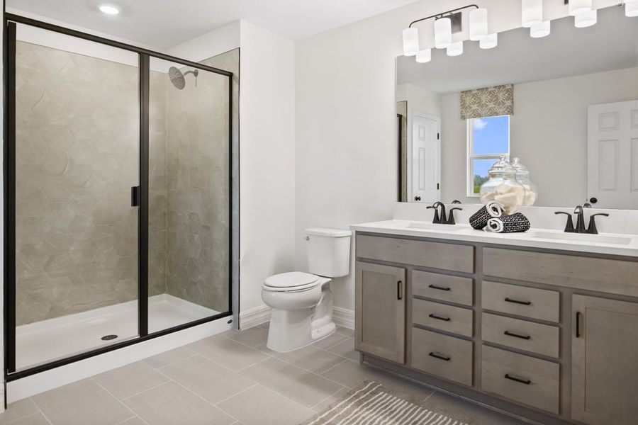 Walk-in shower with tile surround at primary bath