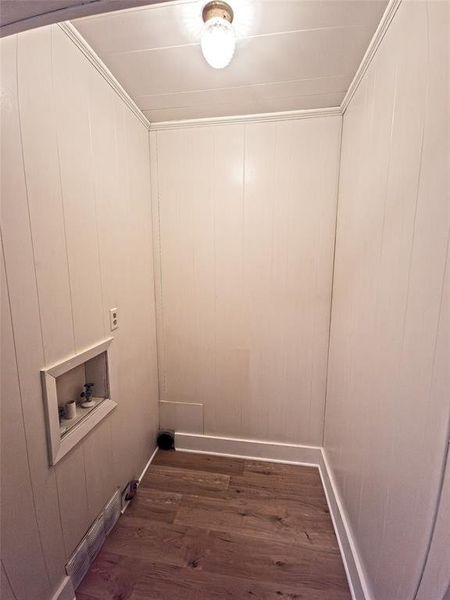 Washroom with dark wood-style floors, washer hookup, and crown molding Washroom with dark wood-style floors, washer hookup, and crown molding