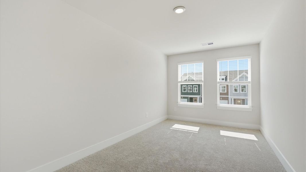 Accomplished bedroom layout with cozy carpet, a spacious walk-in closet, and sun-filled windows at Saluda Crossing Accomplished bedroom layout with cozy carpet, a spacious walk-in closet, and sun-filled windows at Saluda Crossing