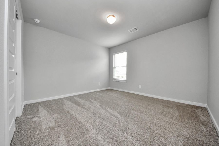 Secondary bedroom features plush carpeting, large windows that let in plenty of natural light, bright paint, and spacious closets. Secondary bedroom features plush carpeting, large windows that let in plenty of natural light, bright paint, and spacious closets.
