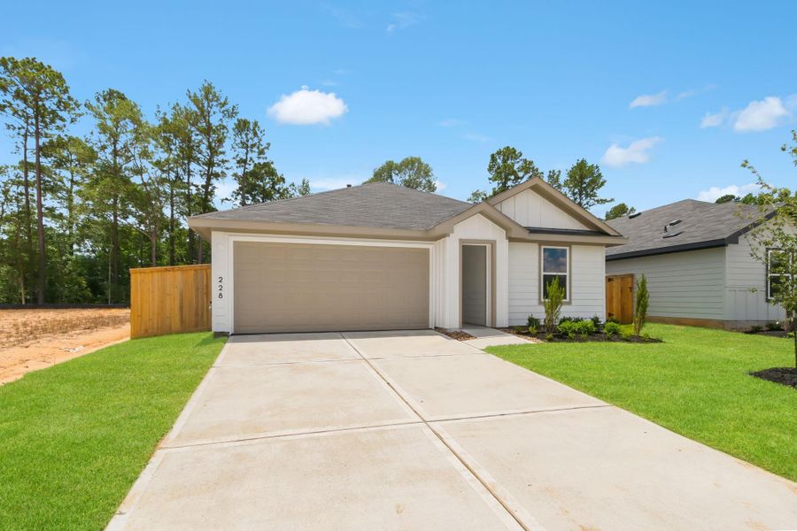 Front exterior of a new home in New Waverly Station, New Waverly, TX, highlighting curb appeal (Image 2). Front exterior of a new home in New Waverly Station, New Waverly, TX, highlighting curb appeal (Image 2).