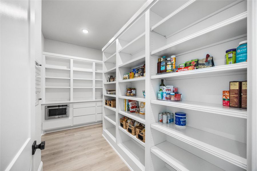 Walk-Pantry with additional storage space and electrical outlets.