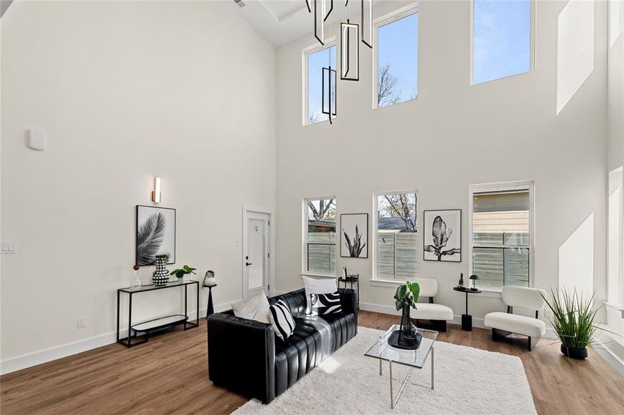 Living room featuring dark wood-type flooring and baseboards