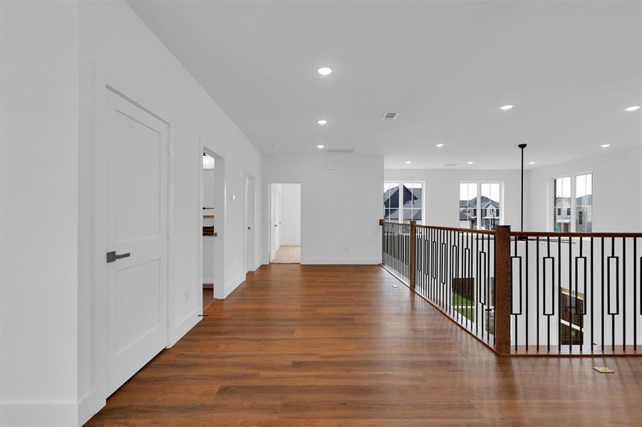 Hall featuring recessed lighting and wood finished floors Hall featuring recessed lighting and wood finished floors