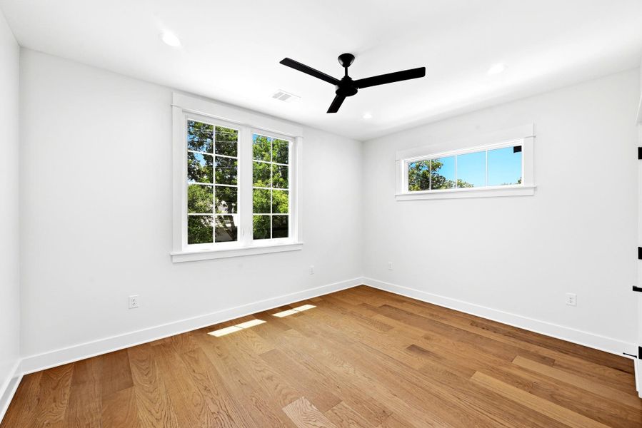 Natural light floods this room, highlighting the warm wood flooring and clean architectural lines. Natural light floods this room, highlighting the warm wood flooring and clean architectural lines.