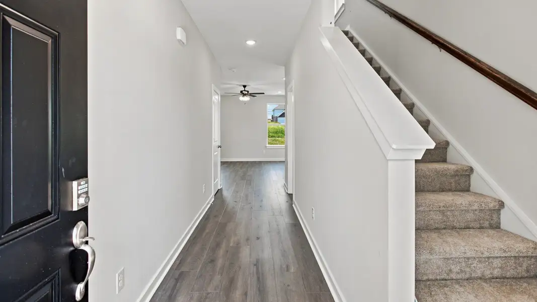 Immediate hallway and stairway entering into the home
