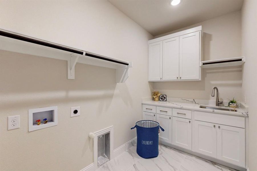 Laundry area featuring cabinets, washer hookup, sink, light tile floors, and hookup for an electric dryer