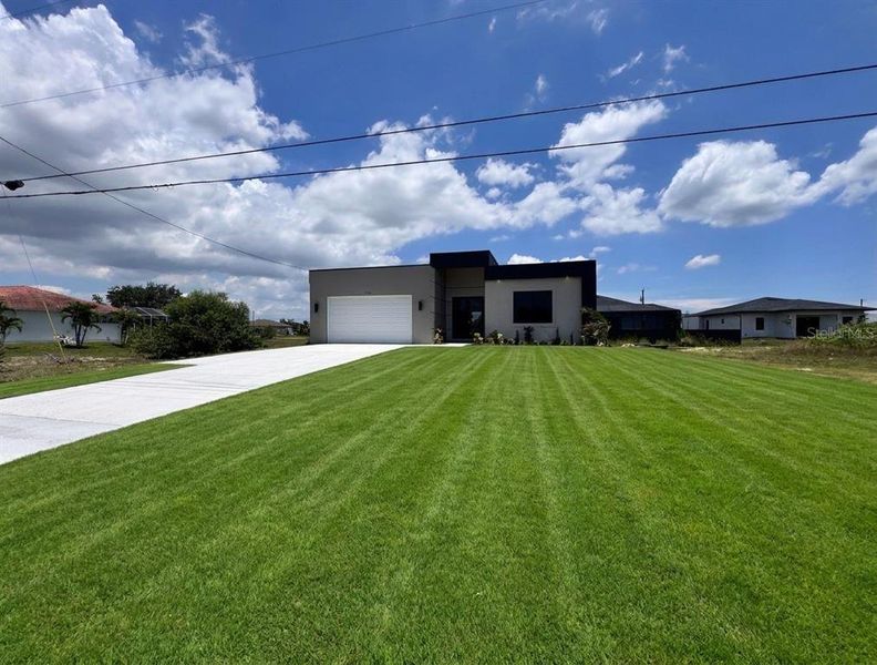 Front exterior of a new home in , Cape Coral, FL, highlighting curb appeal (Image 24). Front exterior of a new home in , Cape Coral, FL, highlighting curb appeal (Image 24).