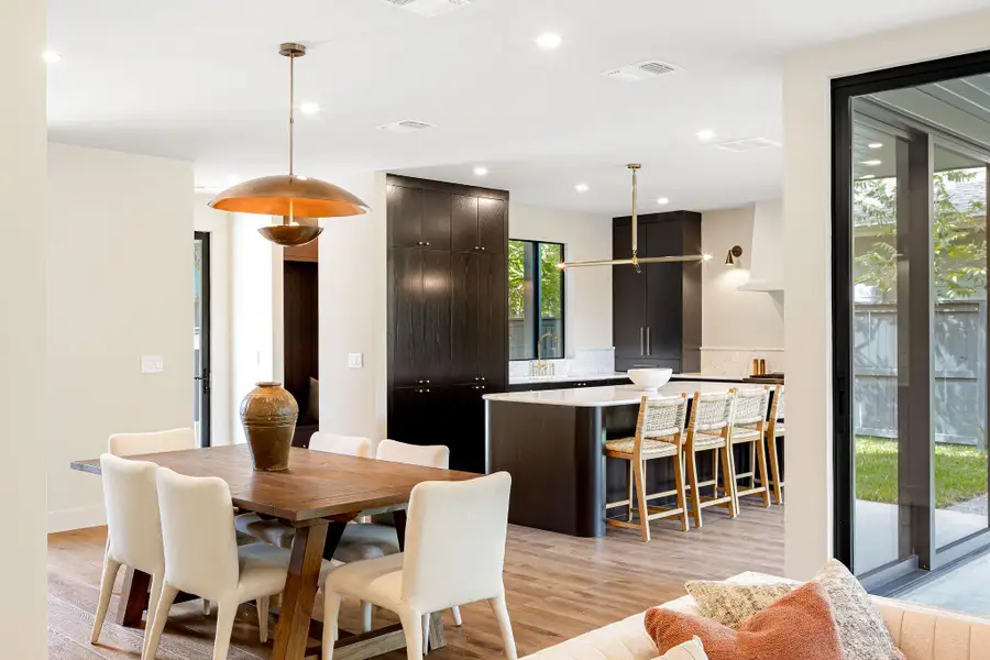 Dining room with light wood-type flooring and recessed lighting Dining room with light wood-type flooring and recessed lighting