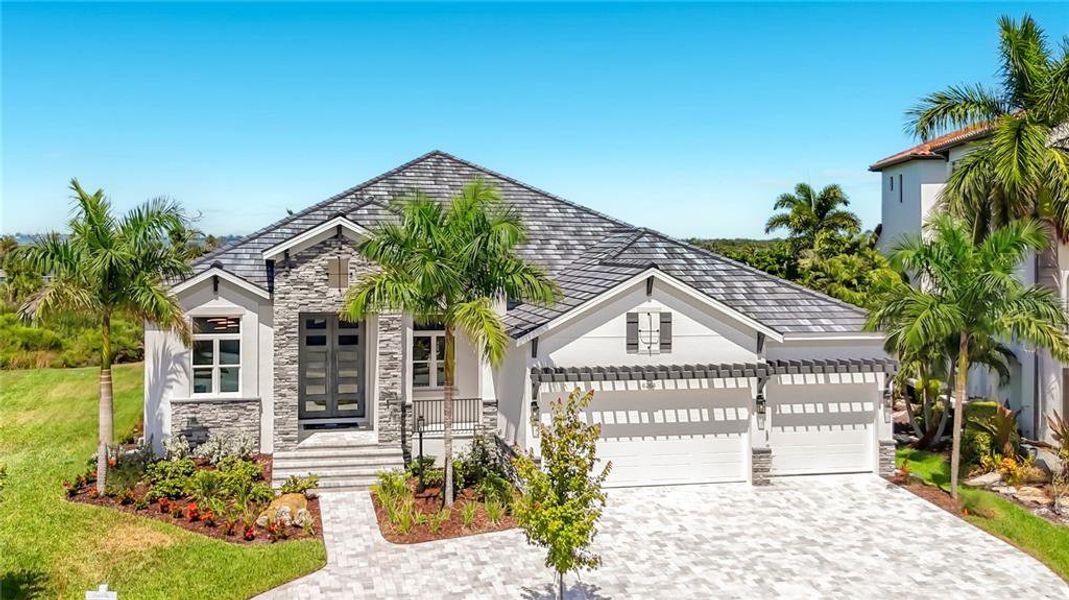 Front exterior of a new home in Legends Bay, Bradenton, FL, highlighting curb appeal (Image 27). Front exterior of a new home in Legends Bay, Bradenton, FL, highlighting curb appeal (Image 27).