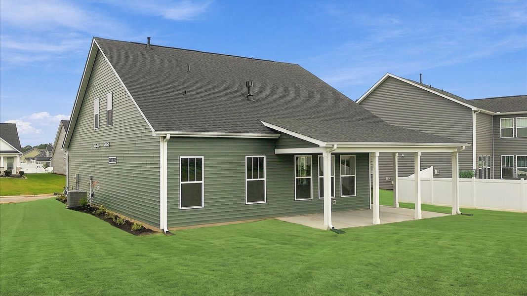 Vibrant rear outdoor space featuring a covered porch and exceptional craftsmanship