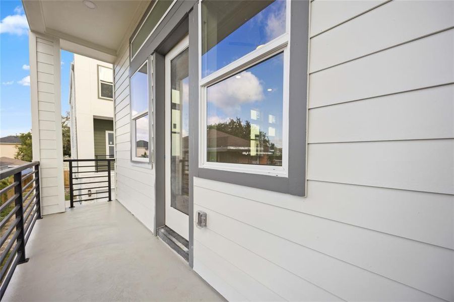 The modern covered balcony area features a clear view of the new community and established surroundings!