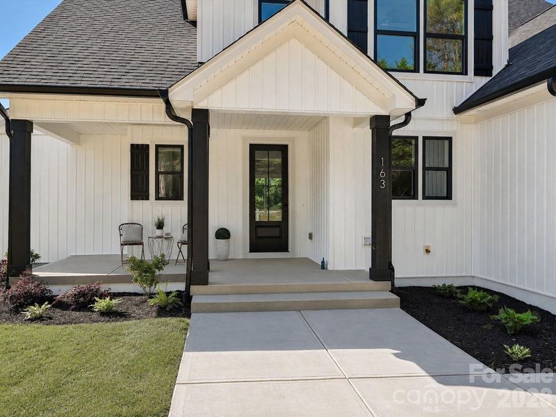 Charming covered front porch creates a warm and inviting welcome home experience.