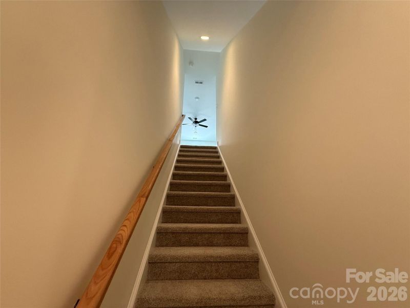 Carpeted stairs lead to the third bedroom...