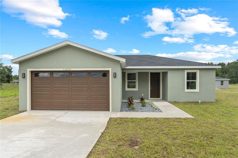 Front exterior of a new home in , Dunnellon, FL, highlighting curb appeal (Image 2).