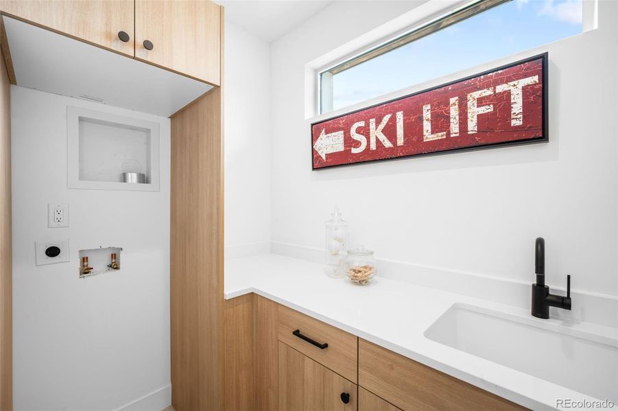 Laundry room with utility sink, storage and stackable W/D hookups