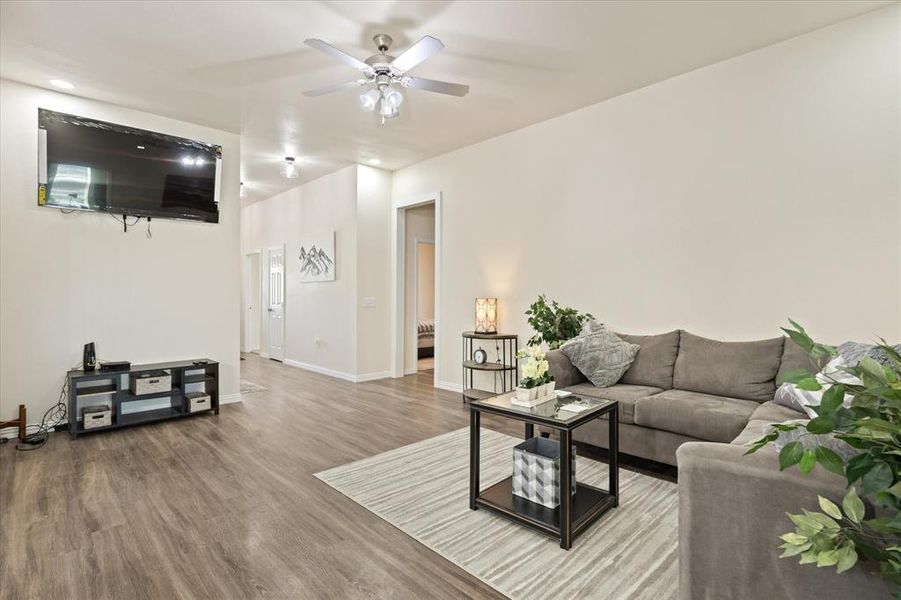 Living room with hardwood / wood-style floors and ceiling fan