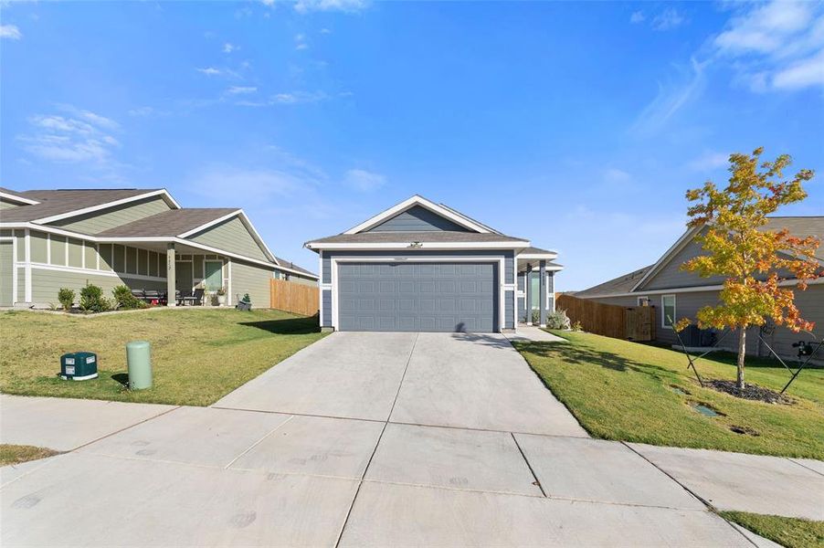 Ranch-style house with driveway and a garage