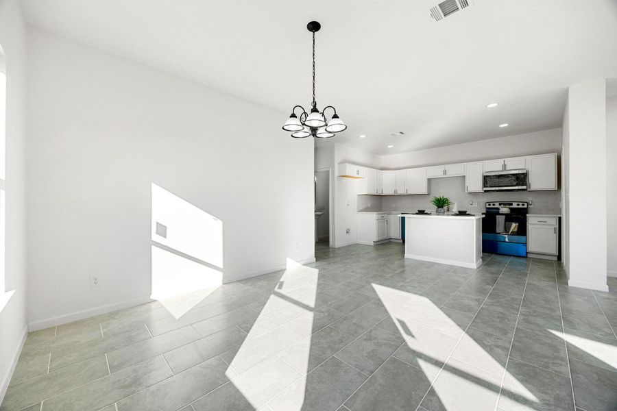 Embrace the bright, open-concept dining and kitchen area, featuring sleek tile floors, tasteful lighting, and contemporary cabinetry—perfect for gatherings and entertaining Embrace the bright, open-concept dining and kitchen area, featuring sleek tile floors, tasteful lighting, and contemporary cabinetry—perfect for gatherings and entertaining