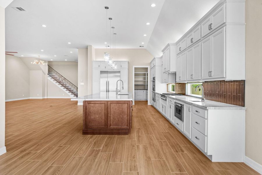 Gorgeous kitchen layout featuring an oversized center island, pendant lighting, and premium finishes throughout.