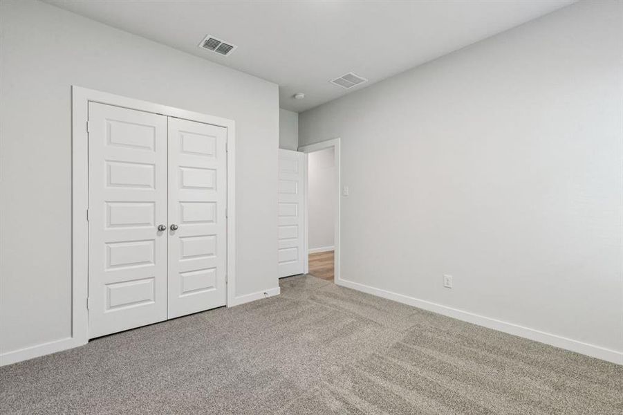 Bedroom in the Oscar home plan by Trophy Signature Homes – REPRESENTATIVE PHOTO