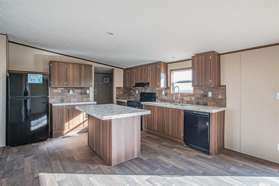 Kitchen with sink, kitchen island, and black appliances