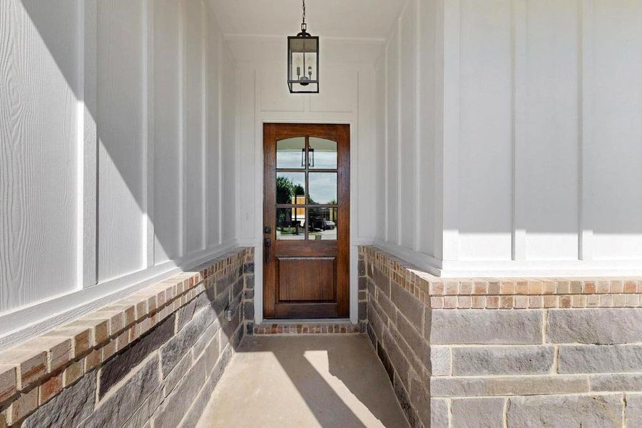 Entrance to property featuring a porch