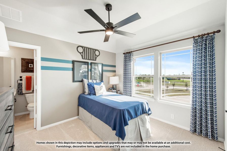 Bedroom with blue accent stripes, ceiling fan, large windows, and attached bathroom visible through open door