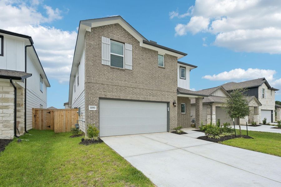Front exterior of a new home in Mavera, Conroe, TX, highlighting curb appeal (Image 20). Front exterior of a new home in Mavera, Conroe, TX, highlighting curb appeal (Image 20).