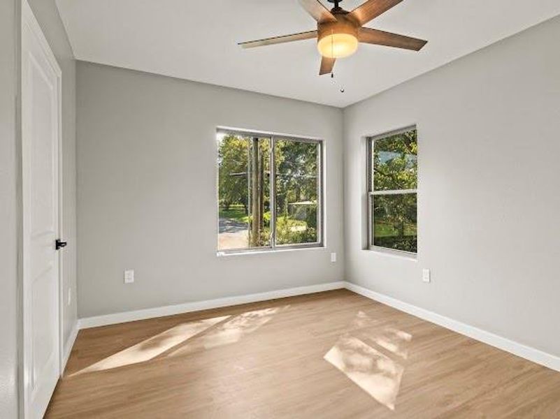 Unfurnished room with light wood-type flooring and ceiling fan