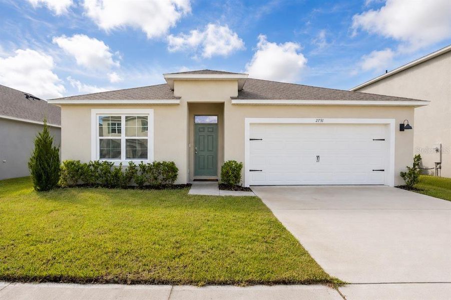 Front exterior of a new home in Harmony West, St. Cloud, FL, highlighting curb appeal (Image 2).