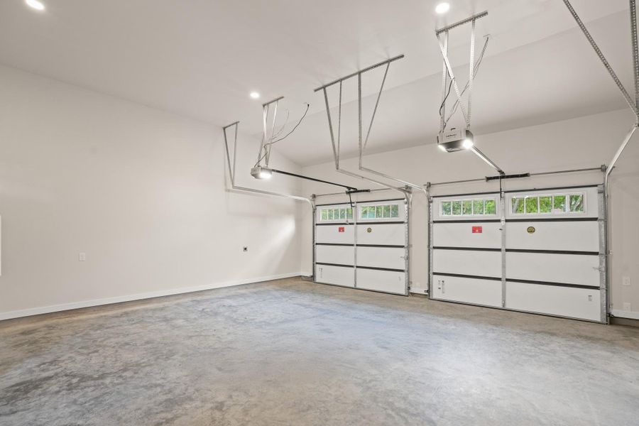 A spacious, pristine garage provides ample parking and convenient automatic door openers. A spacious, pristine garage provides ample parking and convenient automatic door openers.