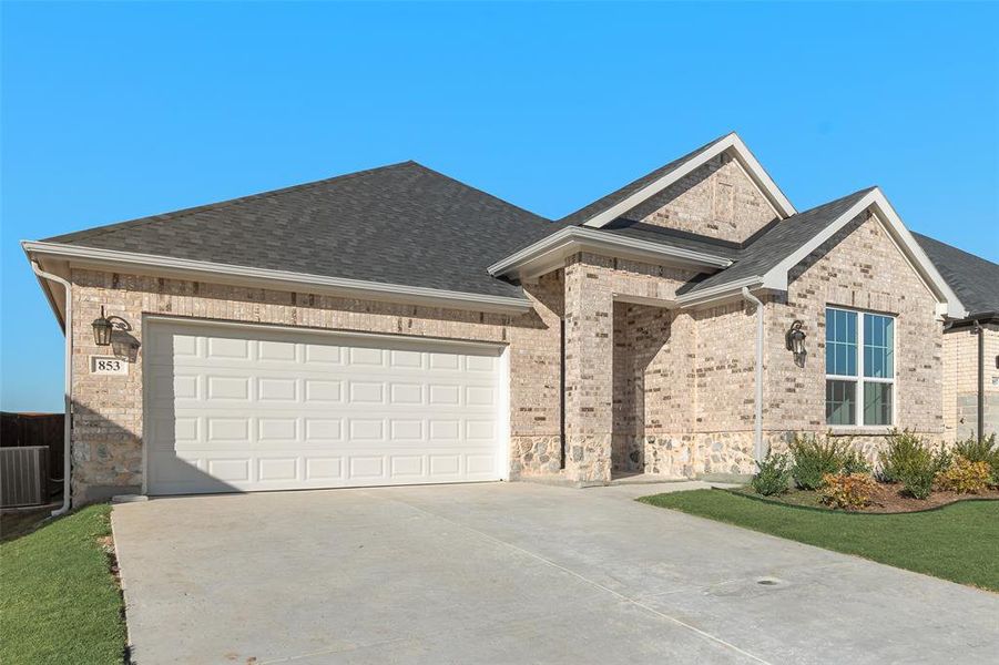 Front exterior of a new home in Wildflower Ranch, Justin, TX, highlighting curb appeal (Image 20).