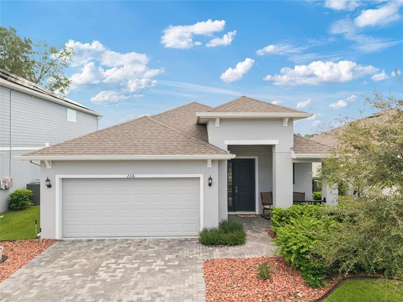 Front exterior of a new home in Summerbrooke, Mount Dora, FL, highlighting curb appeal (Image 23). Front exterior of a new home in Summerbrooke, Mount Dora, FL, highlighting curb appeal (Image 23).