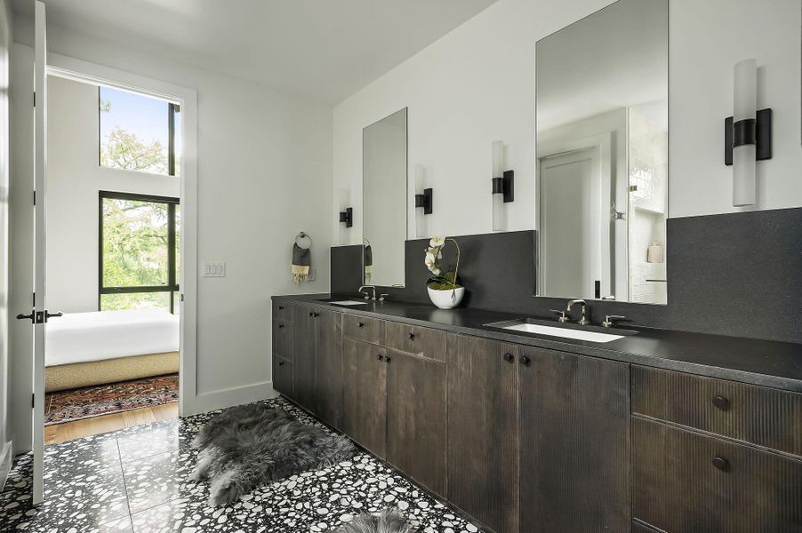 Bathroom with double vanity and baseboards Bathroom with double vanity and baseboards