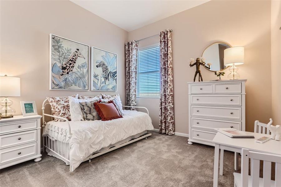 Bedroom featuring light carpet and baseboards