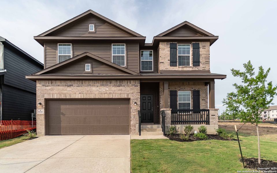 Front exterior of a new home in Mesa Vista, Von Ormy, TX, highlighting curb appeal (Image 1). Front exterior of a new home in Mesa Vista, Von Ormy, TX, highlighting curb appeal (Image 1).