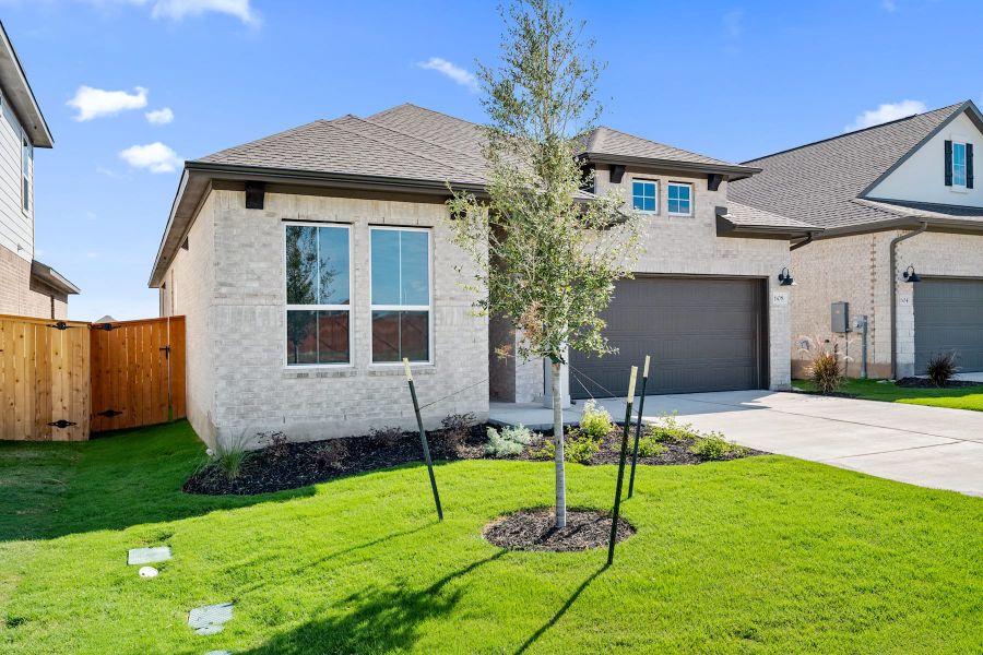 Front exterior of a new home in Lariat, Liberty Hill, TX, highlighting curb appeal (Image 22).