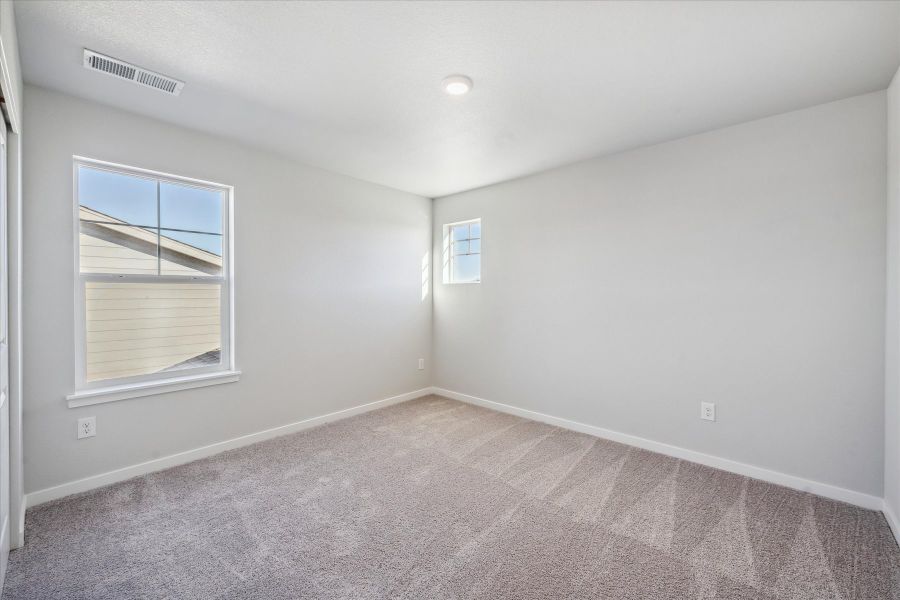 A room with a window and a rug. A room with a window and a rug.