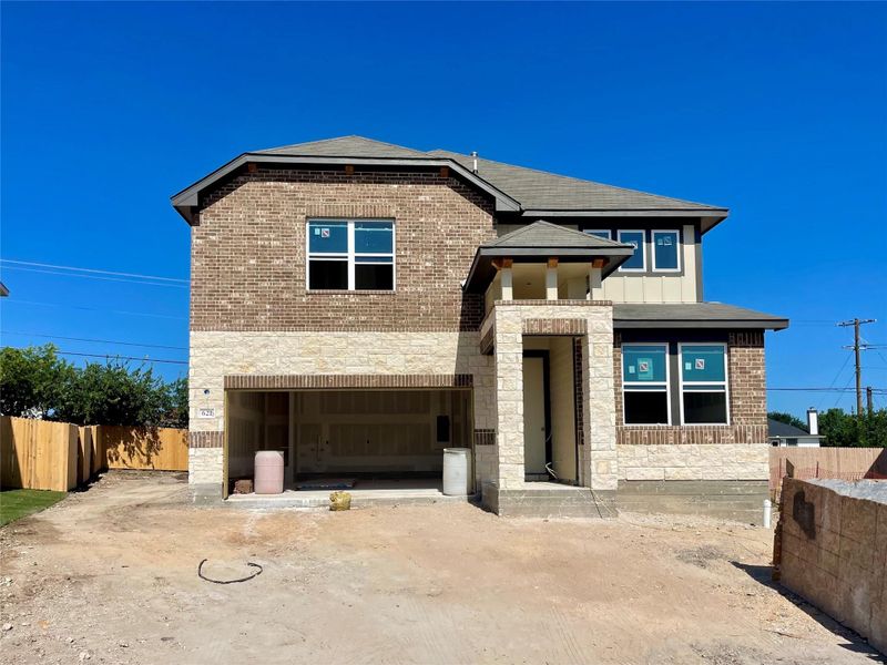 Front exterior of a new home in Covered Bridge, Hutto, TX, highlighting curb appeal (Image 2). Front exterior of a new home in Covered Bridge, Hutto, TX, highlighting curb appeal (Image 2).