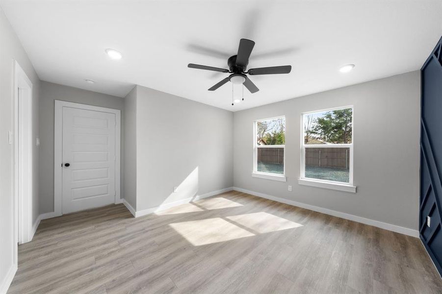 Spare room featuring light wood-style floors, a ceiling fan, and recessed lighting Spare room featuring light wood-style floors, a ceiling fan, and recessed lighting