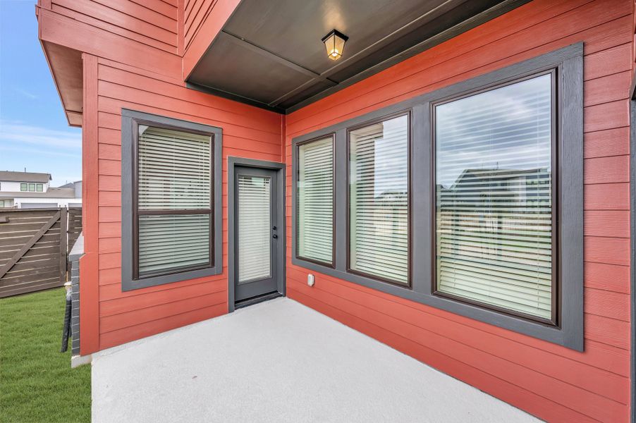 Exterior details and patio area of a home in Indigo - Cottages Row Collection, Richmond (Image 3).