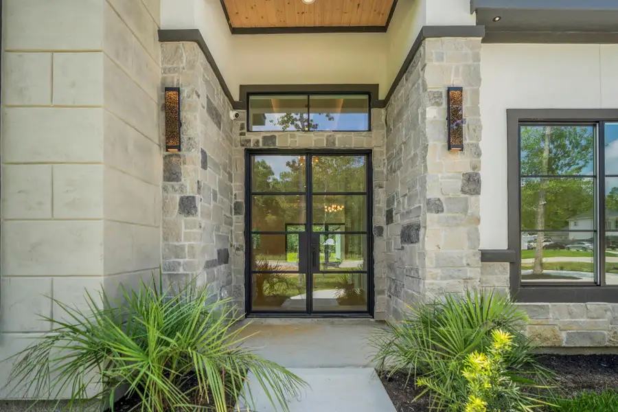 This beautiful entryway provides plenty of covered front doorway space and the modern wrought iron double doors with 8 paned glass gives a sophisticated touch. This beautiful entryway provides plenty of covered front doorway space and the modern wrought iron double doors with 8 paned glass gives a sophisticated touch.