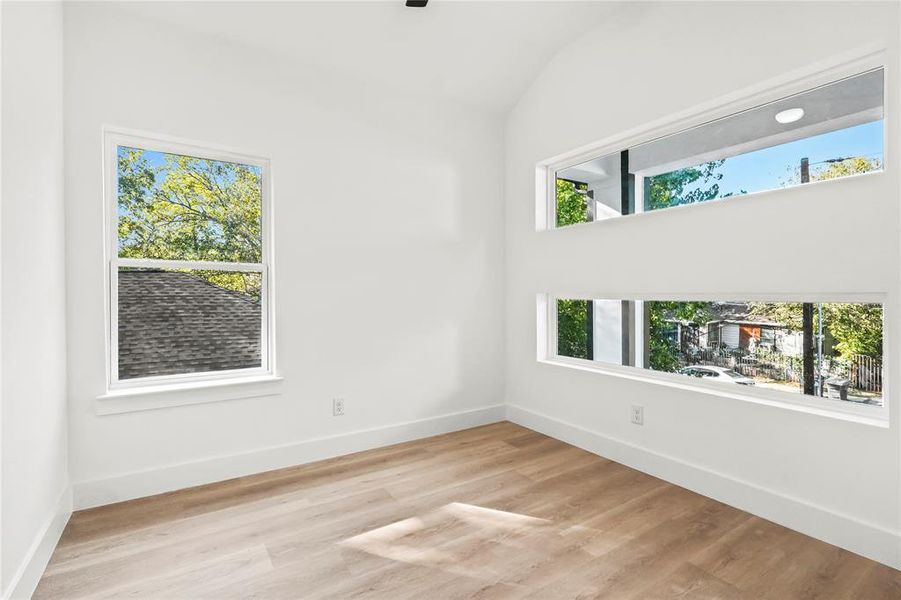 Empty room with light wood-style flooring and baseboards